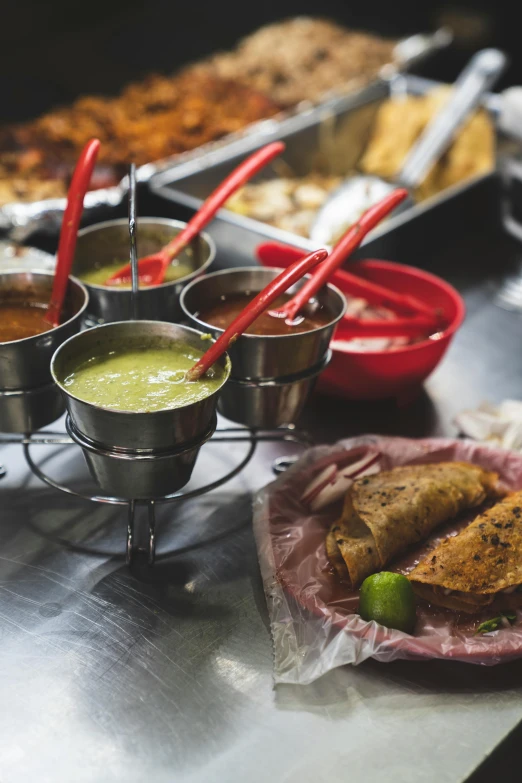 a table topped with lots of different types of food, salsa vendor, stainless steel, thumbnail, brown