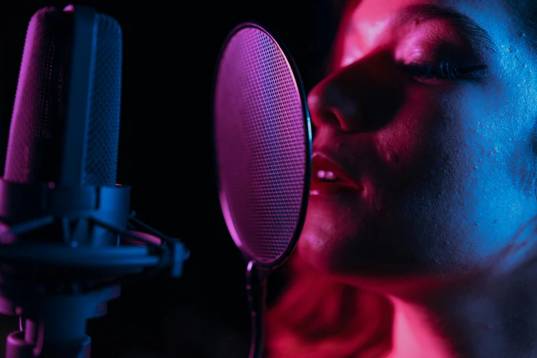 a woman singing into a microphone in a recording studio, trending on pexels, holography, red and blue lighting, avatar image, closeup - view, atmospheric red lighting