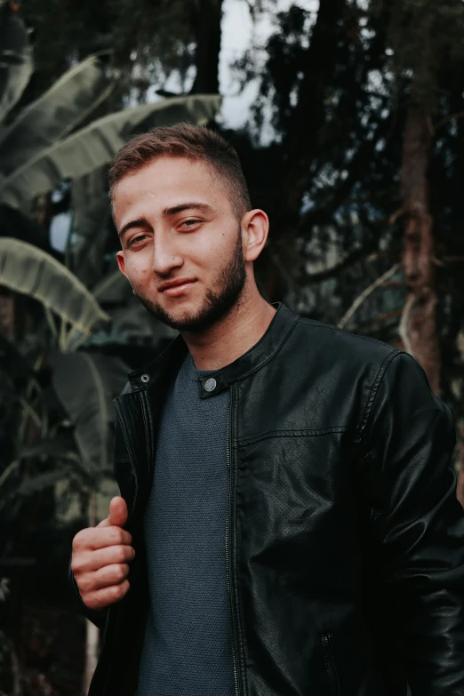 a man in a black jacket posing for a picture, by Robbie Trevino, discord profile picture, in a jungle, artem chebokha, clean background