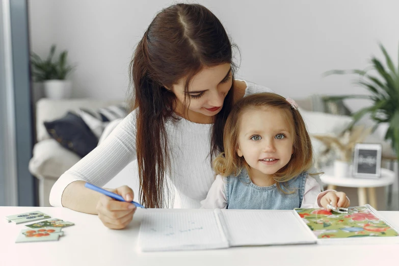 a woman sitting at a table with a little girl, pexels contest winner, academic art, holding notebook, 15081959 21121991 01012000 4k, thumbnail, adorable design