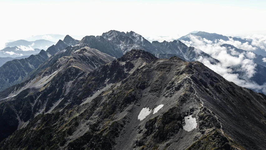 a group of people standing on top of a mountain, a detailed matte painting, by Peter Churcher, trending on unsplash, view from helicopter, new zeeland, 8k detail post processing, high resolution ultradetailed