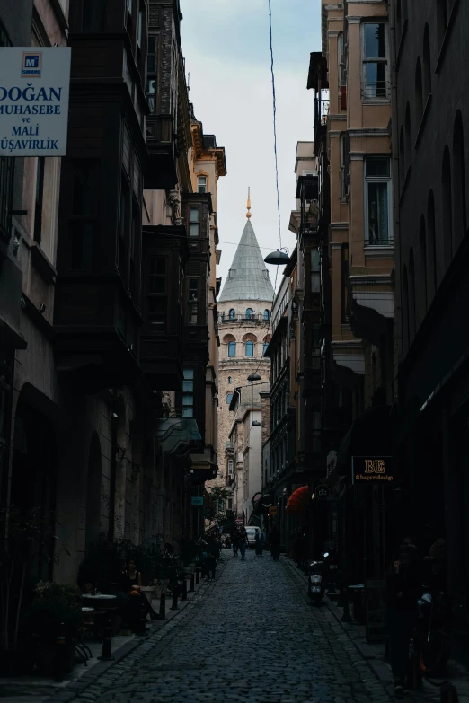 a narrow cobblestone street with a clock tower in the background, a picture, pexels contest winner, hurufiyya, gif, istanbul, church cathedral, multiple layers