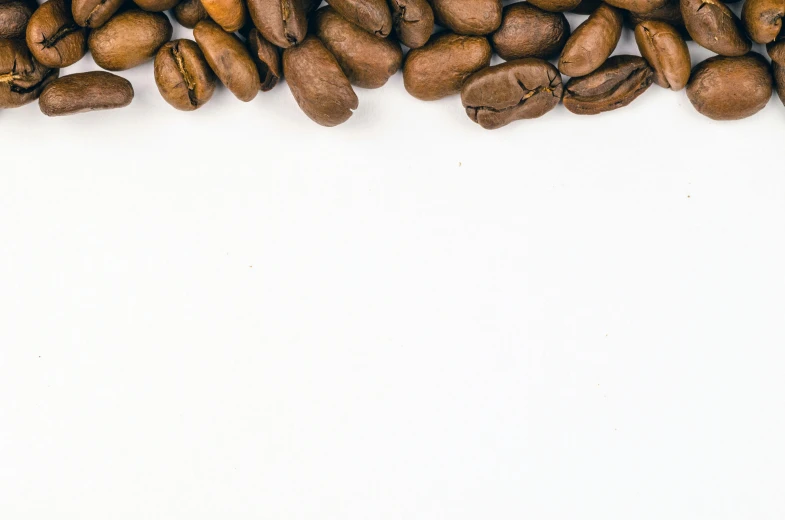 a group of coffee beans on a white surface, trending on unsplash, background image, snapchat photo, detailed product image, thumbnail