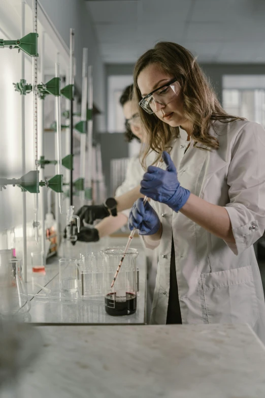 two women in lab coats working in a laboratory, pexels, process art, made of ferrofluid, gif, tall shot, university