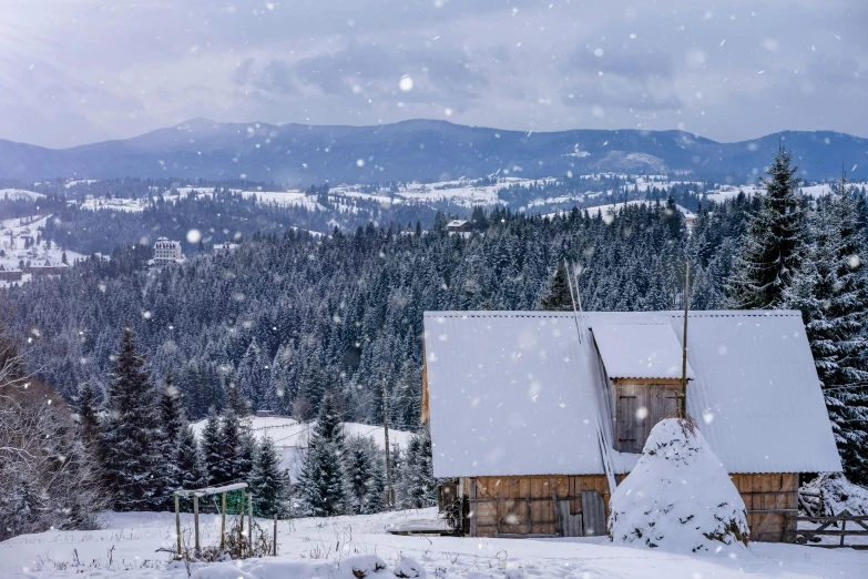 a house in the snow with mountains in the background, by Emma Andijewska, pexels contest winner, renaissance, background image, bosnian, panorama, heavy snow fall