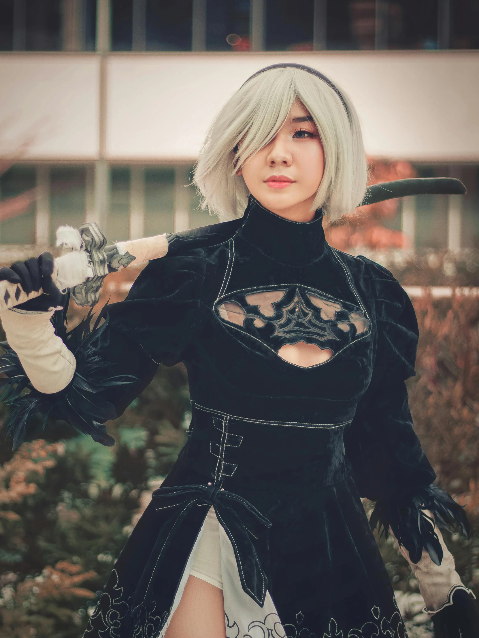 a woman in a black outfit holding a sword, a photo, inspired by Li Chevalier, unsplash, 2b nier automata, cosplayer dressed like a crab, from bravely default ii, snapchat photo