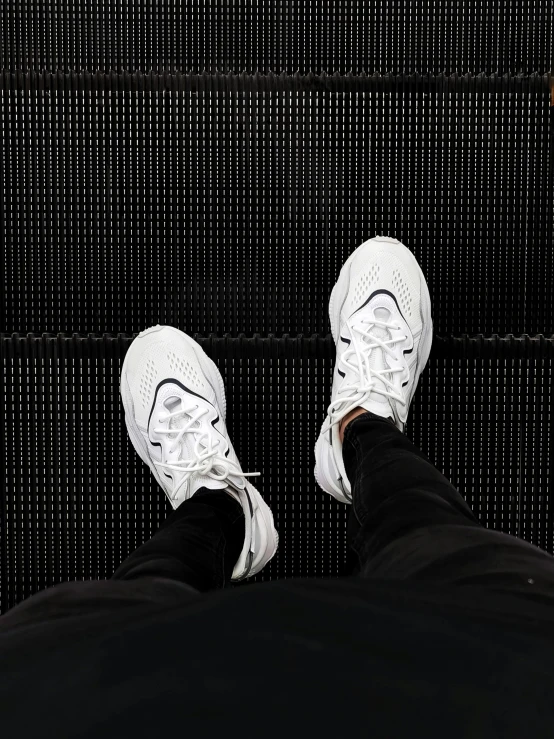 a person standing on an escalator with their feet up, inspired by Salomon van Abbé, trending on unsplash, triple white colorway, nike alpha huarache 7 elite, highly detailed # no filter, ray william johnson