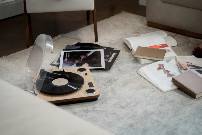 a record player sitting on top of a white rug, wood effect, product display photograph, oak, dynamic angled shot