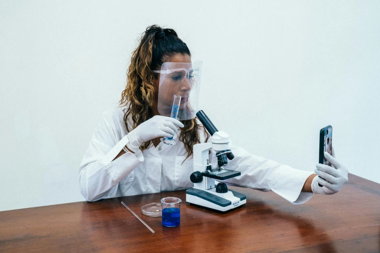 a woman in a lab coat using a microscope, pexels contest winner, hyperrealism, estefania villegas burgos, ferrofluid oceans, 2 0 0 0's photo, fan favorite
