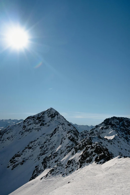 a man riding skis down a snow covered slope, by Matthias Weischer, les nabis, an expansive view of the sun, clear blue sky, two suns, stands at the top