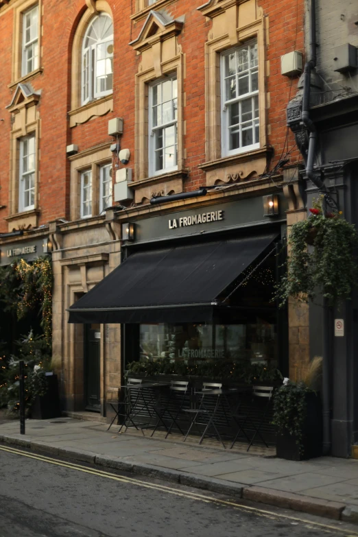 a red brick building sitting on the side of a street, by Lee Loughridge, renaissance, gourmet restaurant, black and terracotta, slide show, laura watson