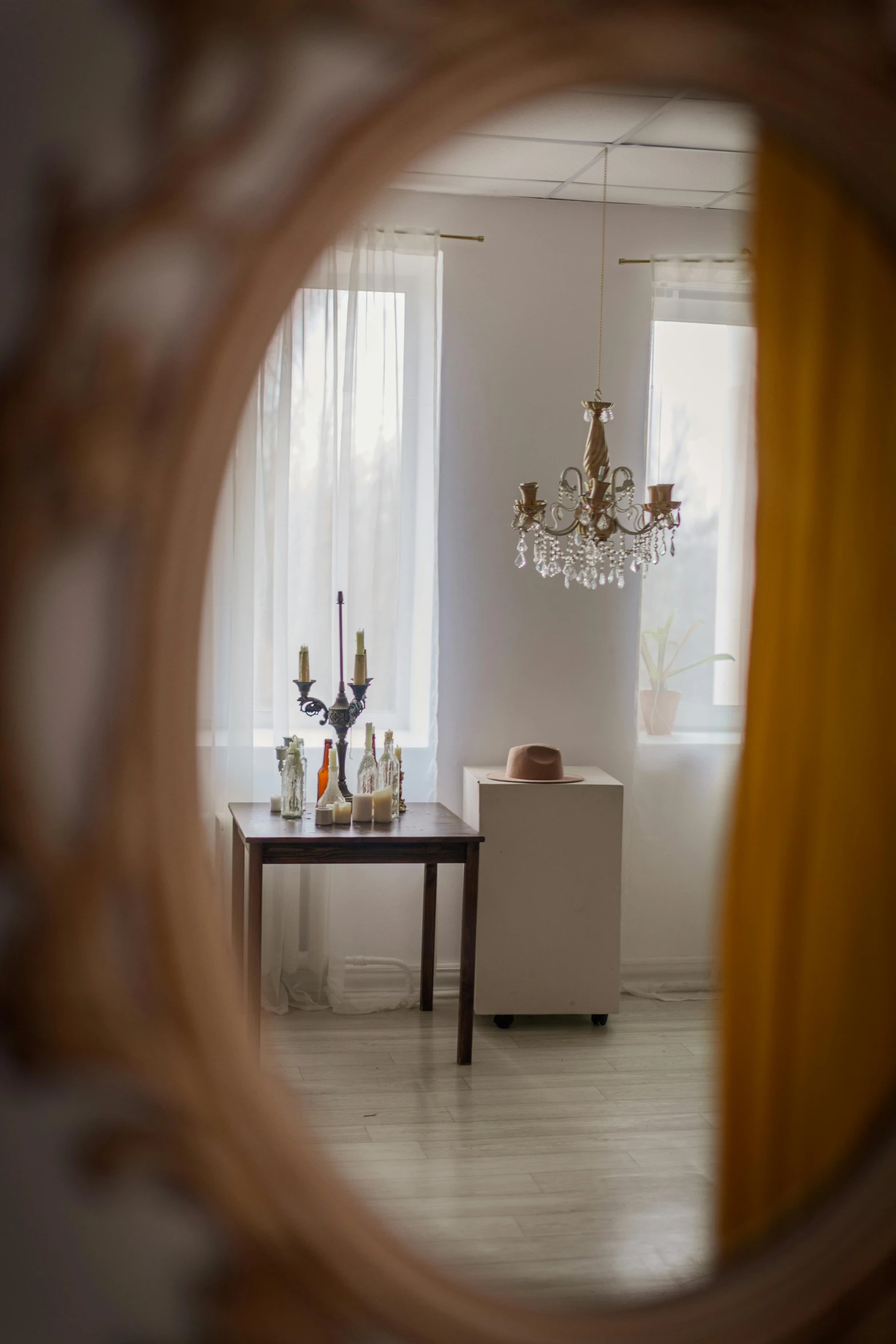 a dining room with a table and a chandelier, a picture, by Konrad Witz, unsplash, rococo, view from behind mirror, in a white boho style studio, ambient amber light, profile image