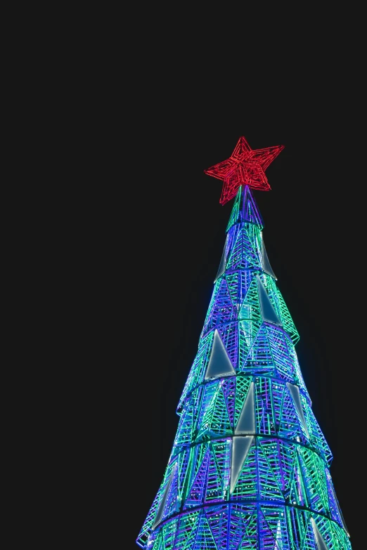 a lighted christmas tree with a star on top, by Adam Marczyński, pexels, video art, 2 5 6 x 2 5 6 pixels, low angle wide shot, giant led screens, intricate illuminated lines