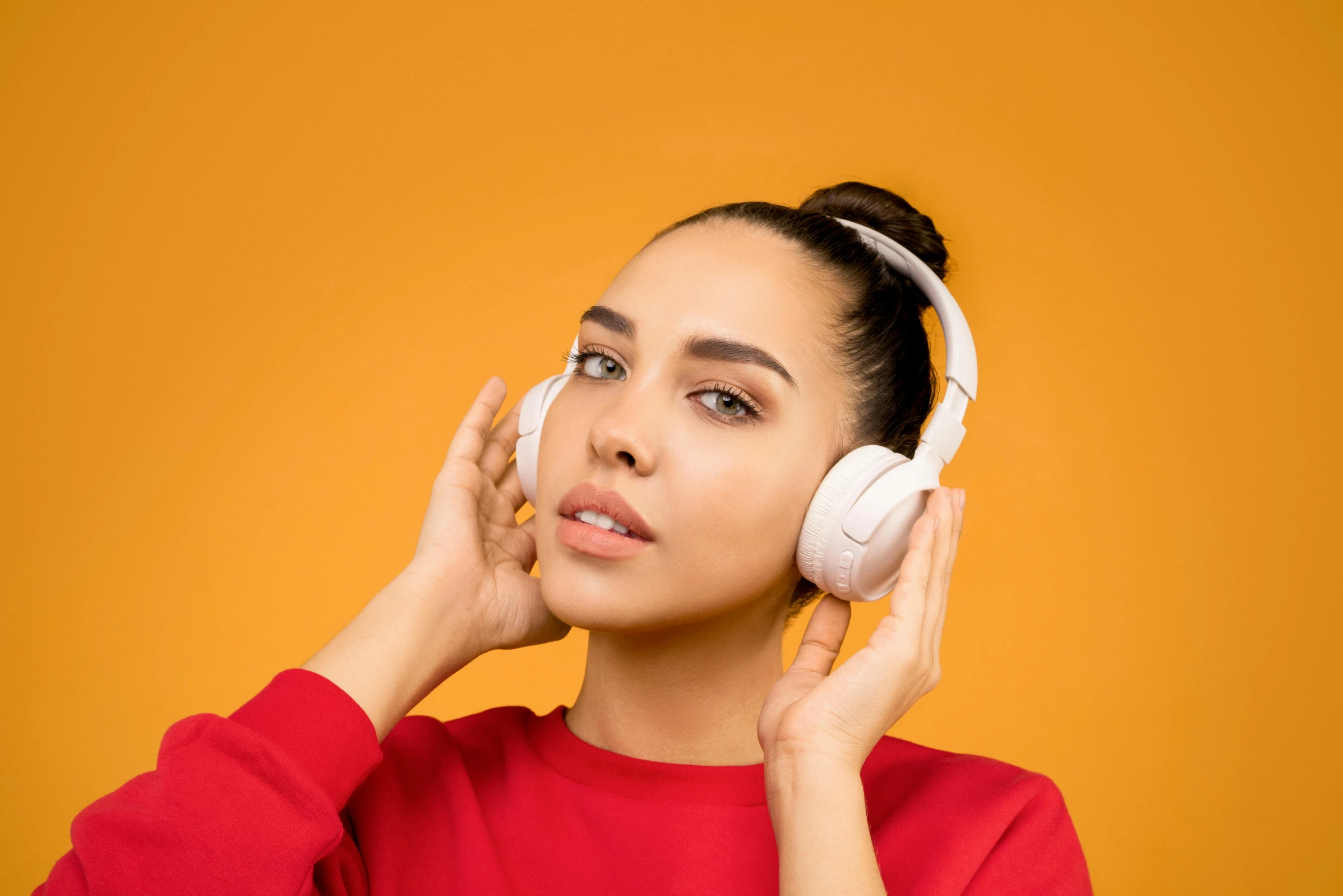 a woman in a red shirt is listening to headphones, trending on pexels, white and orange, photoshoot for skincare brand, thumbnail, modeled