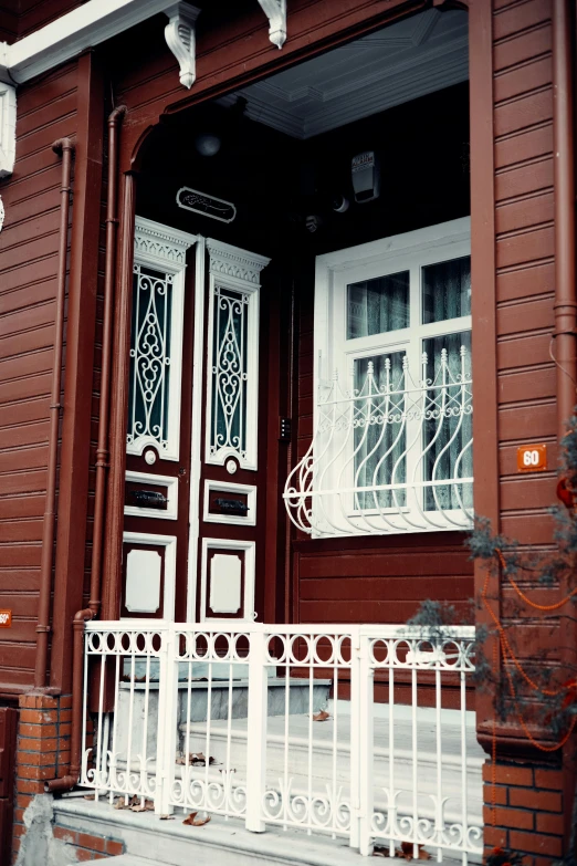 a black and white photo of a red house, inspired by Vladimir Borovikovsky, flickr, art nouveau, brown and white color scheme, entrance, photo 1998, wooden houses