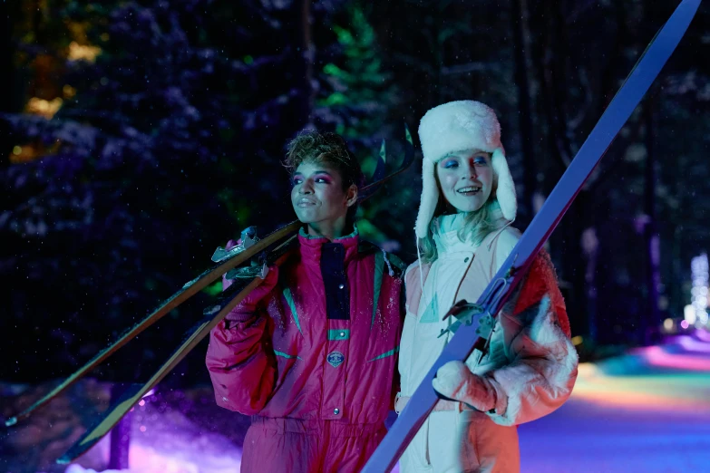 a couple of people standing next to each other holding skis, aurora aksnes and zendaya, elle fanning at night, pink forest, getty images