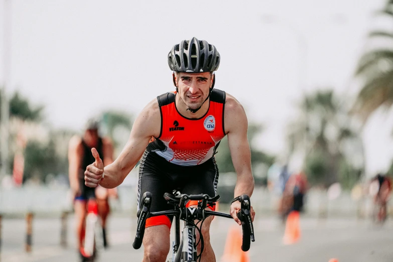 a man on a bike giving a thumbs up, a portrait, by Robbie Trevino, pexels contest winner, in a race competition, avatar image, intense expression, ƒ/5.6