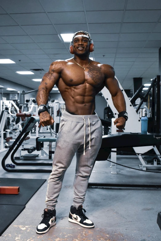 a man posing for a picture in a gym, profile image, david uzochukwu, his arms spread, hyperedetailed photo