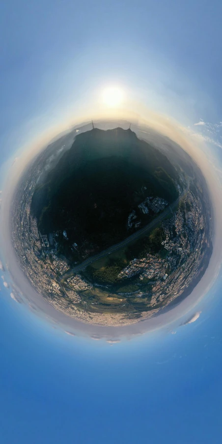 an image of a small planet in the sky, an album cover, unsplash, ((fish eye)), iceland, entire city visible, atmospheric 8k