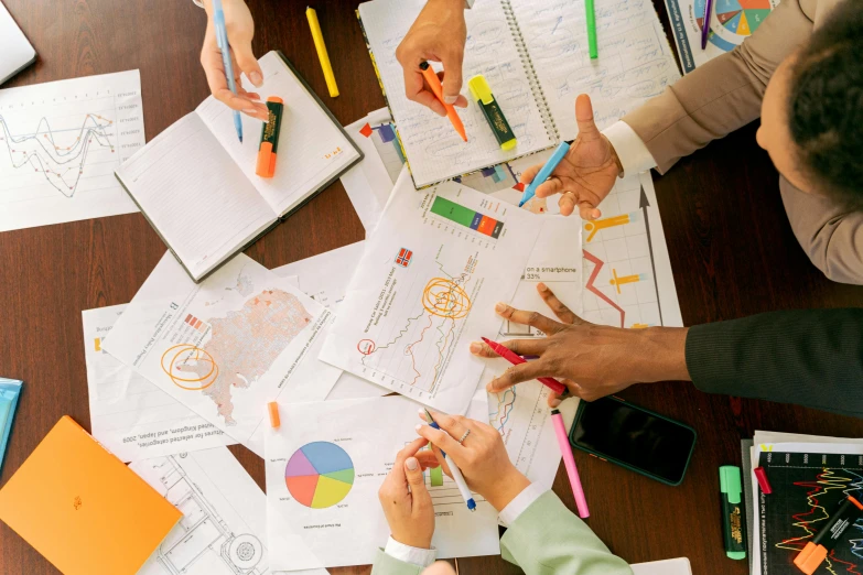 a group of people sitting around a wooden table, pexels, analytical art, poster paper with notes, charts, multi colour, thumbnail