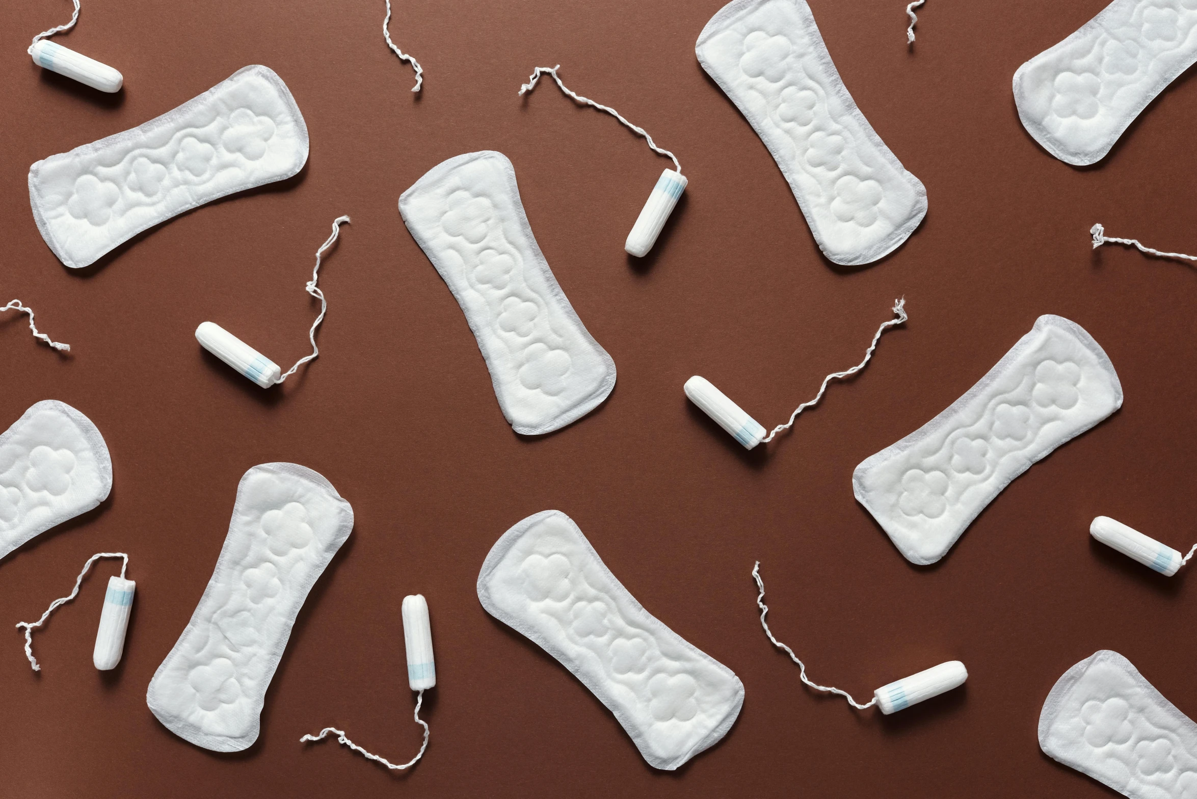 a group of sanitary pads laying on top of a brown surface, inspired by Ödön Márffy, trending on pexels, plasticien, white sweeping arches, repeating, on a pale background, vibrating