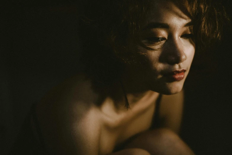 a woman sitting in the dark with her eyes closed, pexels contest winner, australian tonalism, beautiful asian woman, 🤤 girl portrait, soft light 4 k, sensual features