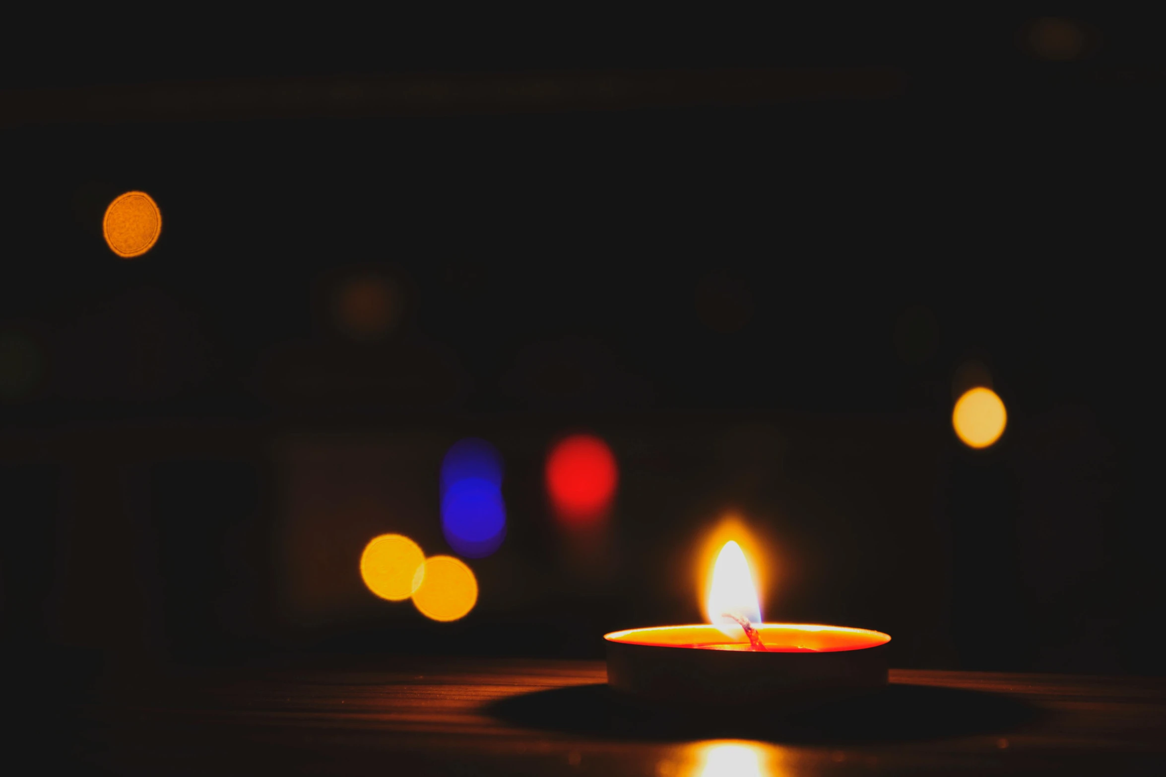 a lit candle sitting on top of a wooden table, profile picture, vibrant lights, instagram post, desktop wallpaper