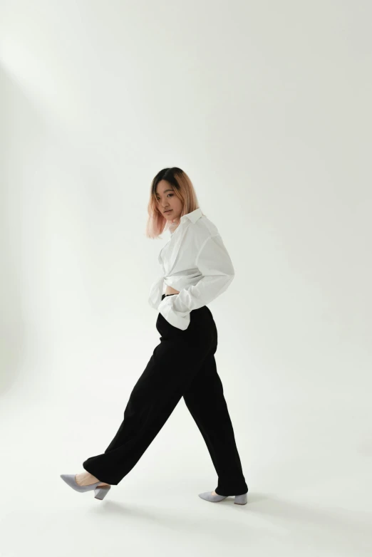 a woman in a white shirt and black pants, inspired by Feng Zhu, trending on unsplash, realism, zaha hadi, non binary model, joy ang, baggy black pants