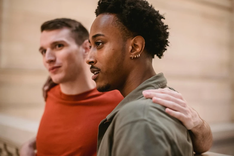 a couple of men standing next to each other, by Nina Hamnett, trending on pexels, renaissance, medium skin tone, looking from shoulder, gay, a group of people