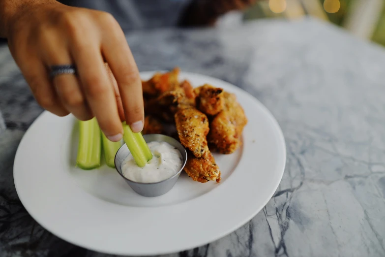 a close up of a plate of food with celery, pexels contest winner, renaissance, real wings, sleek hands, white, grey