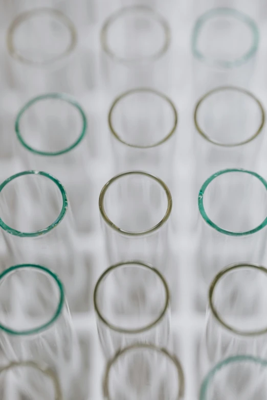 a bunch of glasses sitting on top of a table, a microscopic photo, by Alison Watt, unsplash, pathology sample test tubes, round-cropped, bottom - view, made of lab tissue