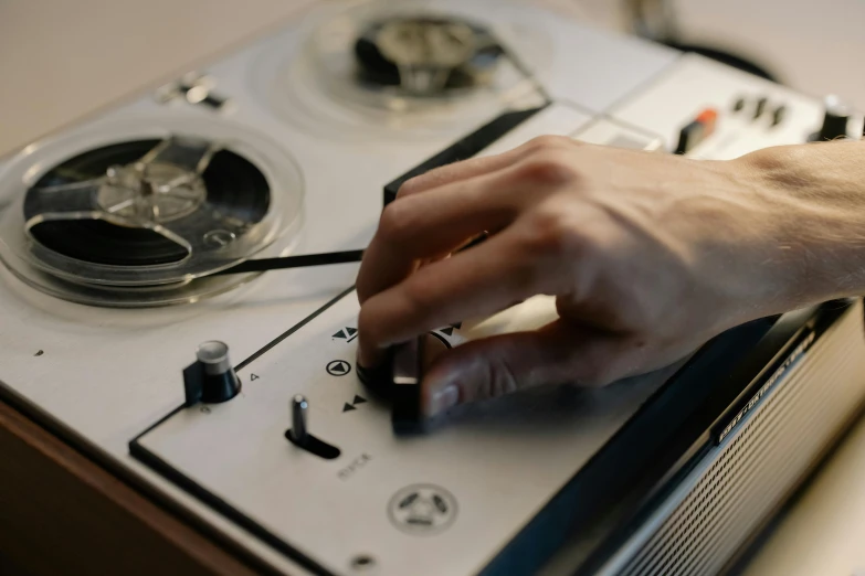 a close up of a person using a tape recorder, trending on pexels, process art, white, ignant, hands on counter, a handsome