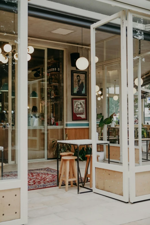 a view of the outside of a coffee shop, a portrait, trending on unsplash, art nouveau, nesting glass doors, iconostasis in the bar, low quality photo, in chippendale sydney