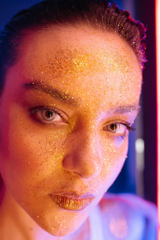 a close up of a woman with glitter on her face, an album cover, trending on pexels, glowing yellow face, portrait sophie mudd, pink and gold, shot with sony alpha