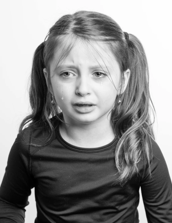 a black and white photo of a little girl, antipodeans, sad emoji, crying big blue tears, photograph taken in 2 0 2 0, taken in the late 2010s