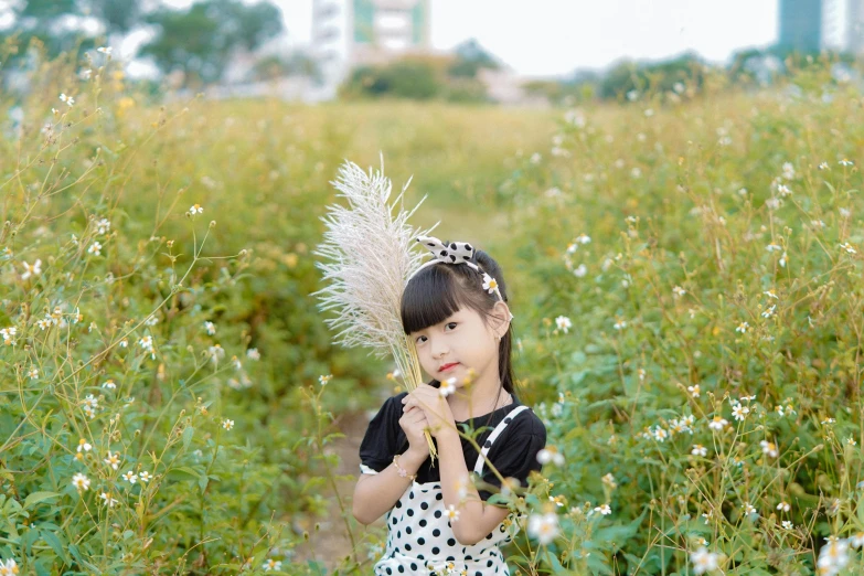 a little girl holding a flower in a field, by Tan Ting-pho, visual art, portrait image, black, straw, instagram picture