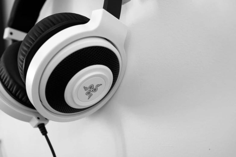 a black and white photo of a pair of headphones, by Adam Marczyński, pixabay, gaming headset, glossy white, /r/razer, with a white background