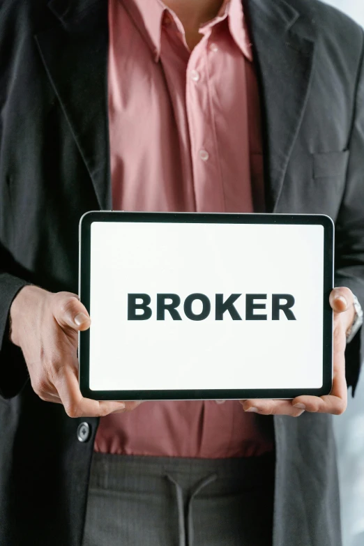 a man holding a tablet with the word broker on it, an album cover, shutterstock, profile pic, markets, 2 0 2 3, technical