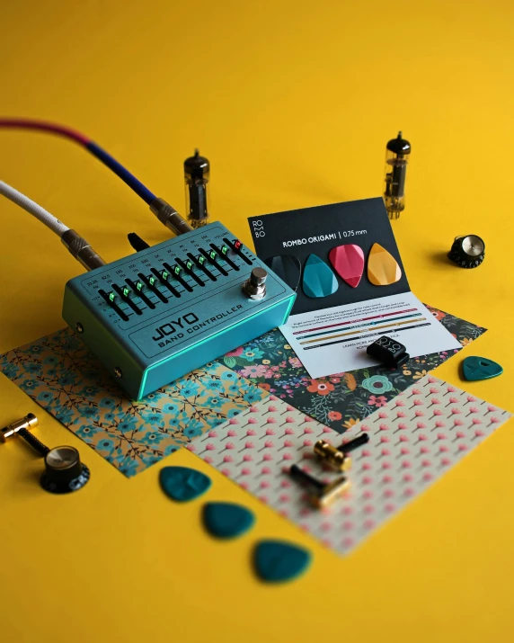 a guitar pedal sitting on top of a yellow surface, inspired by Ottó Baditz, tumblr contest winner, lyco art, teal palette, covered in circuitry, lesbians, singularity sculpted �ー etsy