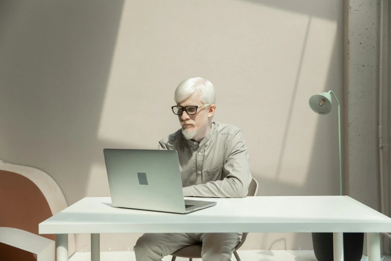 a man sitting at a table with a laptop, a computer rendering, pexels contest winner, intense albino, silver haired, hyperminimalist, ignant