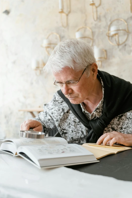 an older woman sitting at a table reading a book, a drawing, pexels contest winner, magnifying glass, over his shoulder, silver haired, inspect in inventory image