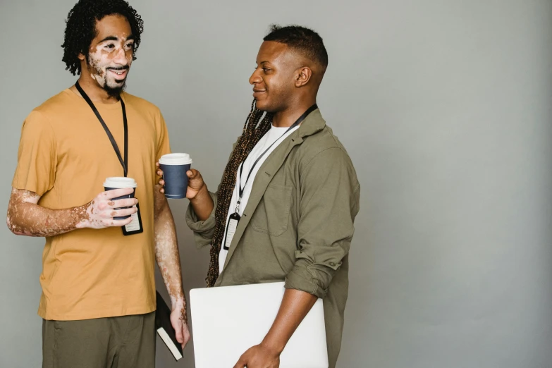 a couple of men standing next to each other, trending on pexels, next to a cup, communication, varying ethnicities, promotional image