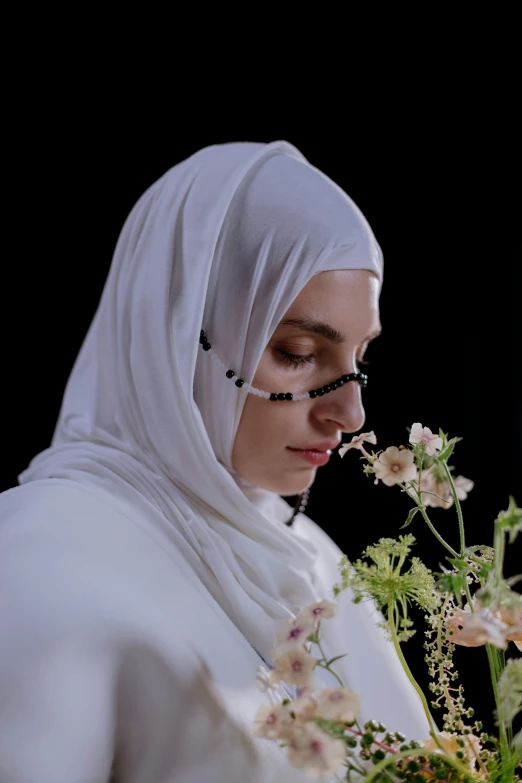 a woman in a white hijab holding a bouquet of flowers, an album cover, inspired by Maryam Hashemi, unsplash, hyperrealism, film still from the movie, taken with sony alpha 9, 8 k film still, profile pic
