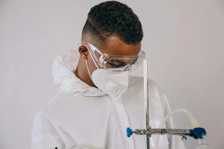 a close up of a person in a lab coat, by Adam Marczyński, pexels contest winner, intubation equipment, streetwear, black man, white mask