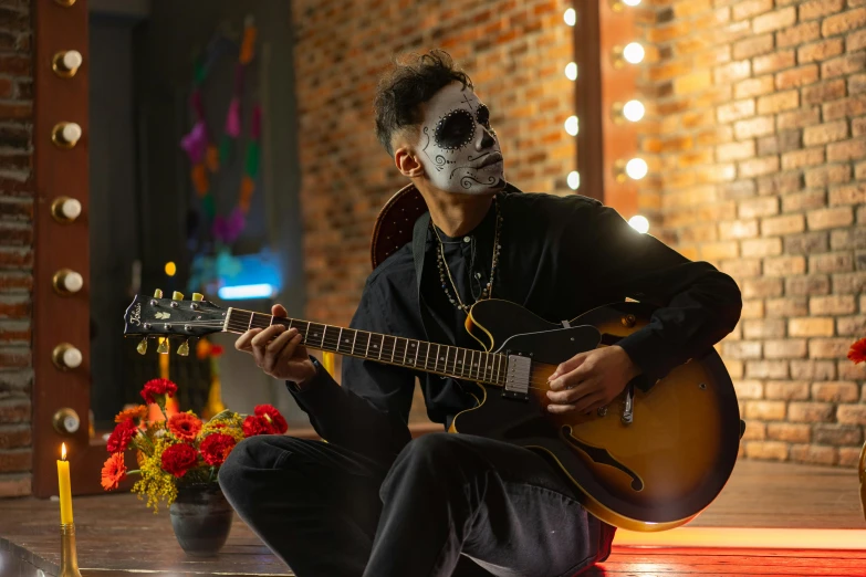 a man sitting on the ground playing a guitar, pexels contest winner, vanitas, dia de los muertos makeup, avatar image, profile image, full face view