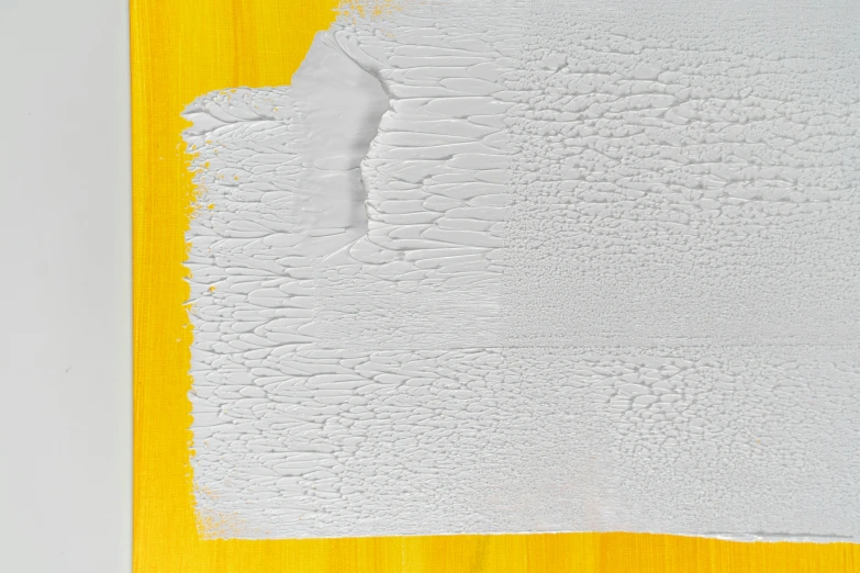 a piece of white paint on a yellow piece of wood, inspired by Lucio Fontana, pexels, lyrical abstraction, grey, promo image, herman nitsch, detailed product image