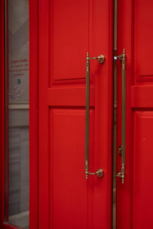 a couple of red doors sitting next to each other, metal handles, commercial photograph, brass, about
