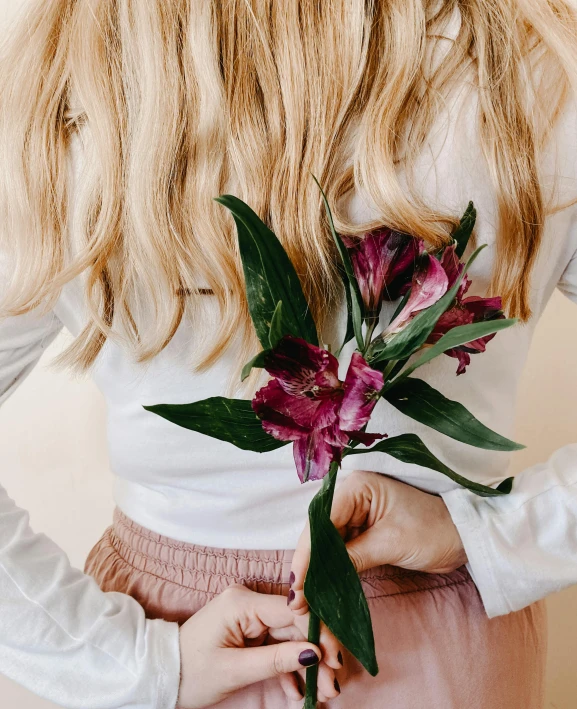 a woman holding a bunch of flowers in her hands, by Alice Mason, trending on unsplash, lily petals, young blonde woman, outfit photo, product introduction photo