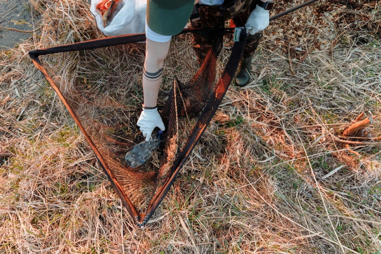 a person riding skis across a grass covered field, a portrait, by Emma Andijewska, land art, dragging a pile of chains, mesh roots, high angle close up shot, rectangle