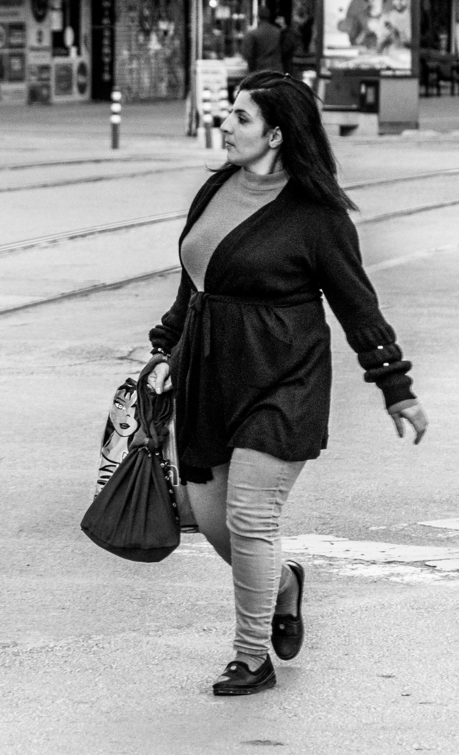 a black and white photo of a woman walking down the street, a black and white photo, by Sven Erixson, pixabay contest winner, figuration libre, a portrait of a plump woman, wearing a cardigan, paparazzi photo, full body photgraph